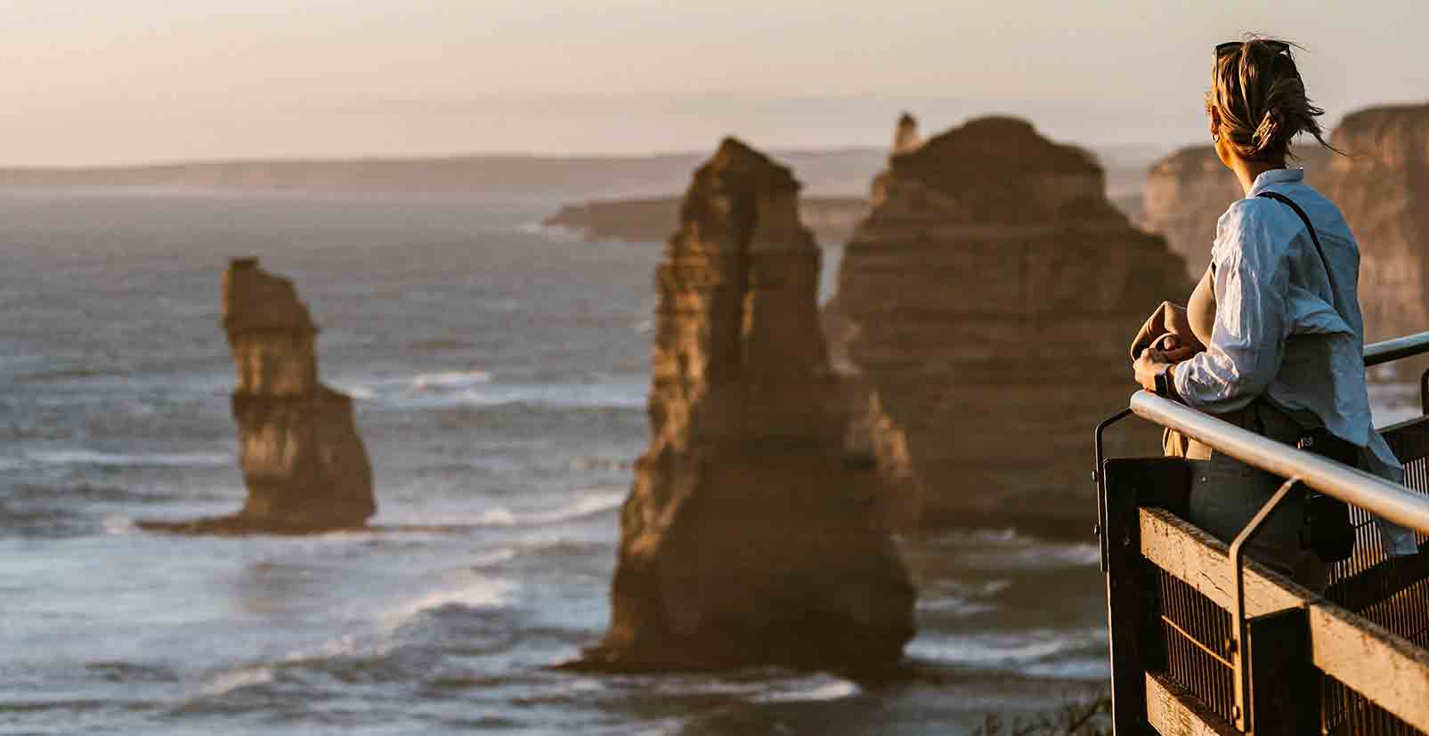 A lady gazes out at the 12 Apostles on the Great Ocean Road